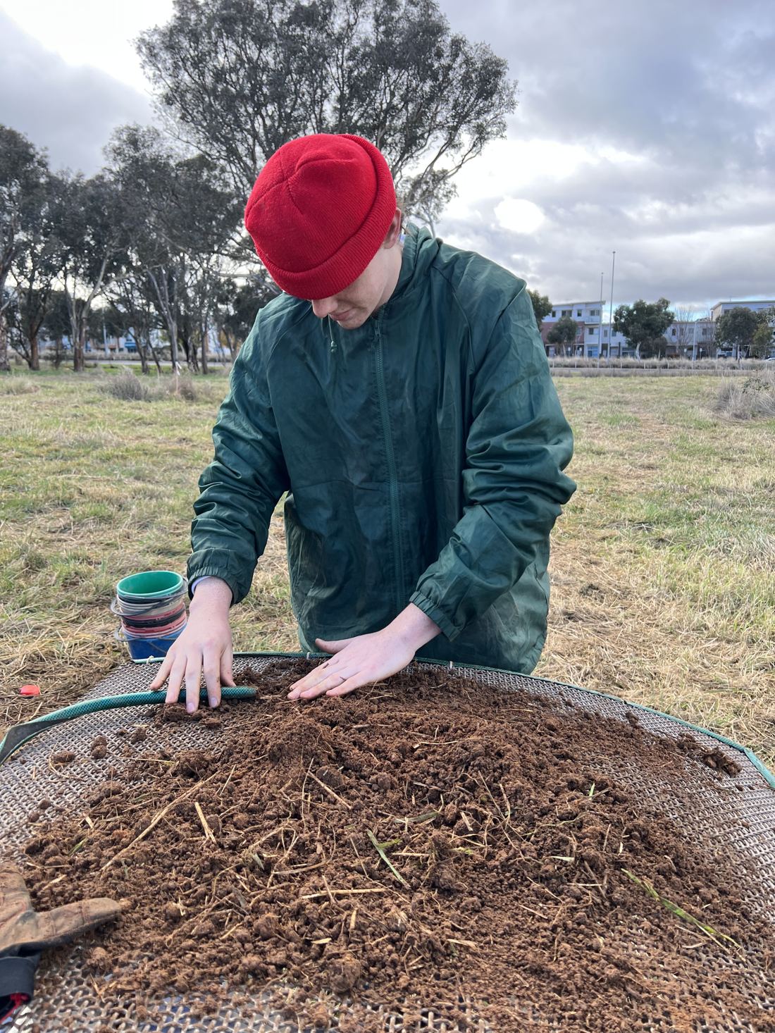 Sieving excavated material during archaeological fieldwork